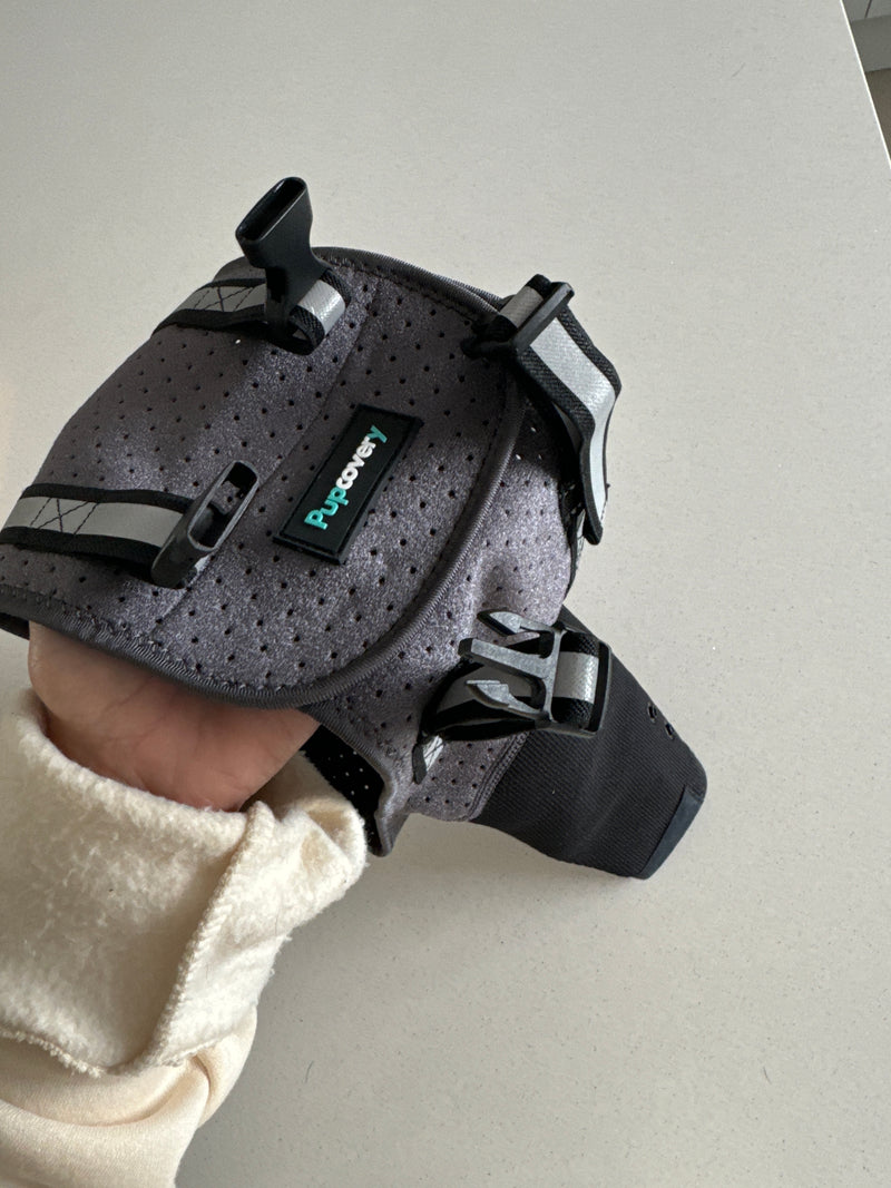 Close-up of a Pupcovery front leg recovery sleeve held in hand